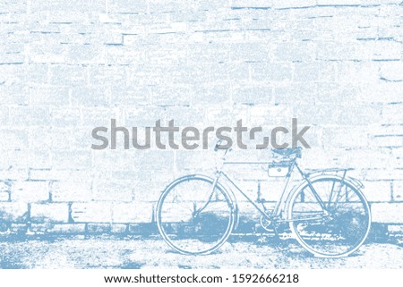 Bicycle on a brick wall background. Photo in processing, with the effect of "coal".