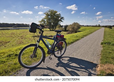 Bicycle On Dyke On The Elbe Bike Lane In Background The German River Elbe, It Is Also The Iron Curtain Trail