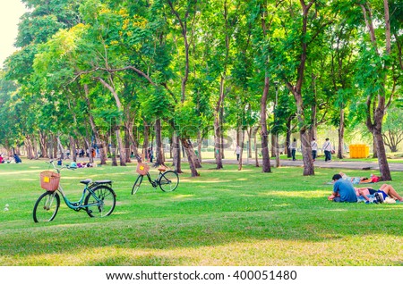 Bicycle on green grass in the park. People relaxing. Happy family enjoy time together outside. togetherness, love, happiness concept.
