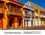 Bicycle parked at the entrance to a traditional building in Cartagena de Indias, Colombia. Spanish street sign "Customs Square"