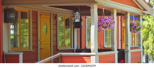 Bicycle Parked Near Modern Traditional Country House Colored With Falu Red Dye. Summer Garden, Green Trees, Flowers, Exterior Decor. Stockholm Sail Club, Mälaren Lake, Sweden. Estate, Architecture