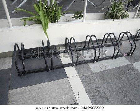 bicycle parking, bicycle parking in city parks, black iron racks for bicycle parking
