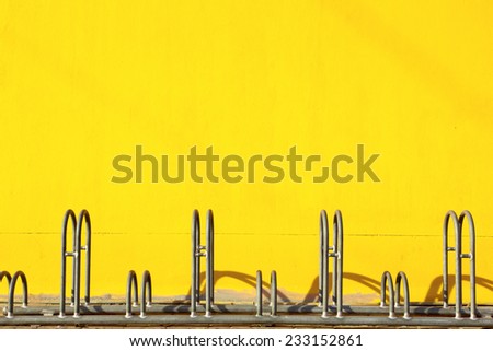 bicycle parking with yellow wall background