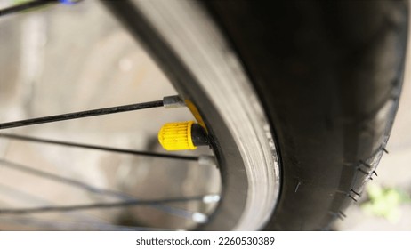 Bicycle parts: bike front wheel and bike tire. 
Cycling: bike day, bicycle ride day.   
Bike parts: inner tube valve.  Bicycle wheel and bicycle tire. 
   - Powered by Shutterstock