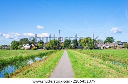 Bicycle path in the Dutch countryside, leading to neighbourhood Zuidbuurt, part of the village of Zoeterwoude-Dorp, The Netherlands.