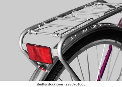 Bicycle rear rack. Close-up. Isolated on light gray background.