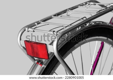 Bicycle rear rack. Close-up. Isolated on light gray background.