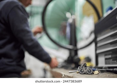 Bicycle repair shop. Conceptual image with selective focus and copy space. Real people at work. - Powered by Shutterstock