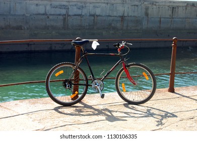 Bicycle Resting On A Railing On A Quay Pier In Foz Do Douro. Porto. Portugal. Europe