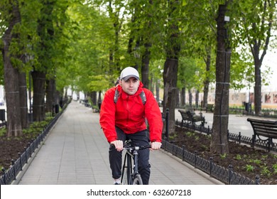 Bicycle Rider In Red Jacket Riding On Park 