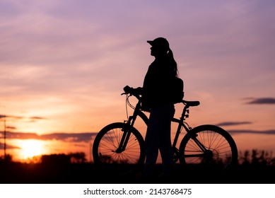 Bicycle Rider Silhouette With Sunset Sky In Background, Girl Riding Her Bike Staring At The Sunny Evening Sky