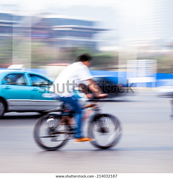bicycle riders in the\
city in motion blur