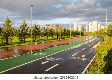 Bicycle and running paths in a modern urban park after rain - Powered by Shutterstock