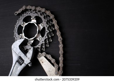 Bicycle Service And Maintenance Equipment. Adjustable Spanner, Chain Whip Tool And Bike Sprocket Isolated Black Background.