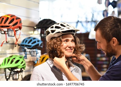 Bicycle shop consulting - customer tests a bicycle helmet for road safety  - Powered by Shutterstock