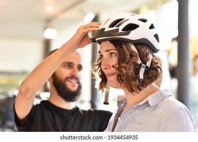 Bicycle shop consulting - customer tests a bicycle helmet for road safety  - Powered by Shutterstock