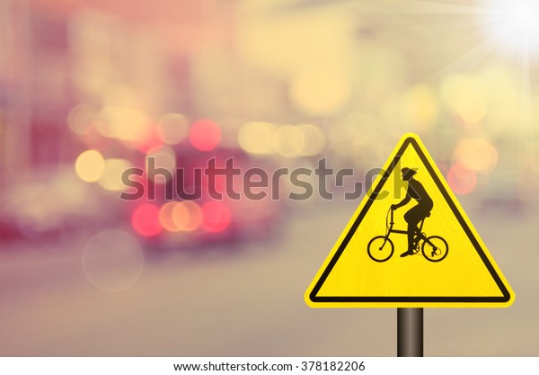 Bicycle sign on blur traffic road abstract\
background.Retro color\
style.