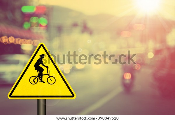 Bicycle sign on blur traffic road abstract\
background.Retro color\
style.
