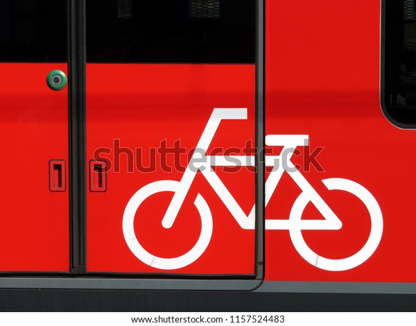 Bicycle sign on the door of the train\
car. Transportation of bikes on railroad or\
bus