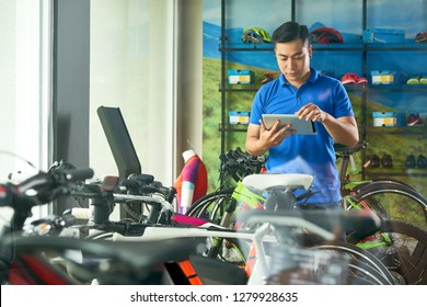 Bicycle Store Manager Checking Information On Tablet Computer