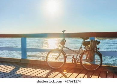 Bicycle and sunrise on the Sea Bridge in Palanga, Baltic Sea resort, Lithuania