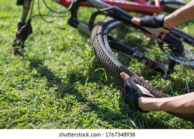 Bicycle tires leak, Cyclists checking bicycle wheels, Close-up. - Powered by Shutterstock