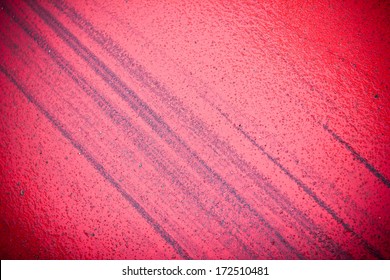 Bicycle Tyre Mark On Red Road Texture