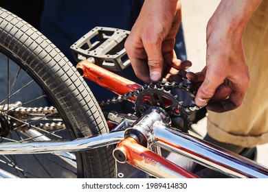 Bicycle Undercarriage Repair. The Process Of Pulling The Chain Onto The Sprocket. Unrecognizable Person. Close-up