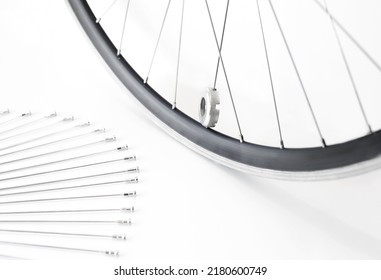 bicycle wheel and spare spokes, on an isolated white background