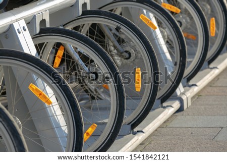 Bicycle wheels with orange retroreflector and Cat-Eye on a bicycle close-up in Parking lot