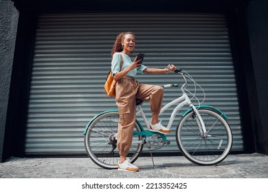 Bicycle  woman   phone in city feeling excited   happy about message while outdoor in summer and trendy look  Eco friendly transportation for carbon footprint female bike using 5g network
