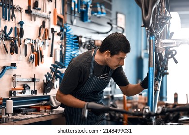 Bicycles are his business. Shot of a man working in a bicycle repair shop. - Powered by Shutterstock