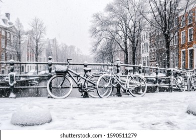 Bicycles on a bridge on a snowy day in Amsterdam, Holland.