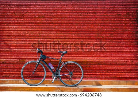 Bicycles parking against red rustic wall of old warehouse