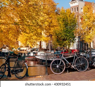 Bicycles Standing Near Amsterdam Canals In Autumn