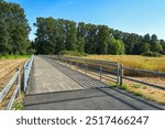 Bicyclists approach the fenced section of the trail at Marymoor Park, Redmond, Washington, USA