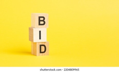 BID - Text On Wooden Blocks, Yellow Background. Business Continuity Management Concept