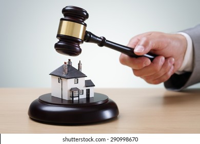 Bidding on a home, gavel and house concept for home ownership, buying, selling or foreclosure