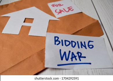 Bidding War And House For Sale Write On Sticky Notes Isolated On Office Desk