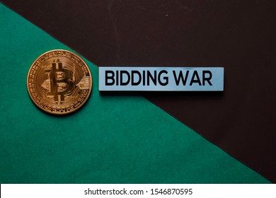 Bidding War Text On Sticky Notes With Bitcoin. Office Desk Background.