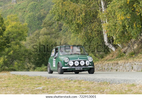 BIELLA / ITALY - SEPTEMBER 24, 2017:\
Vintage car running on country road: a Mini Cooper Export during a\
meeting of historic cars. This model was built in\
1973.