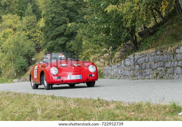 BIELLA / ITALY - SEPTEMBER 24,\
2017: Vintage car running on country road: a Porsche 356 Speedster\
during a meeting of historic cars. This model was built in\
1956.