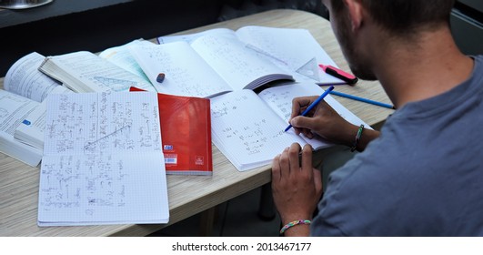 Bielsko, Poland - 07.24.2021: the boy studies late at home. Solving math problems, learning for a test.