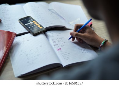 bielsko, Poland - 07.30.2021: the student does his math homework at home. Science of exact sciences. Learning by solving math problems. Preparation for the school-leaving examination