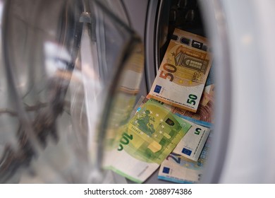 Bielsko, Poland - 12.10.2021: Euro Banknotes In The Washing Machine. Concept Showing Money Laundering. Money From Illegal Activities And Crimes.