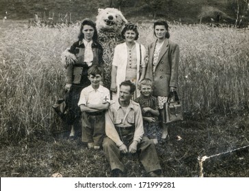 BIELSKO, POLAND, CIRCA 1940s - Vintage Photo Of Happy Family With A Fake Bear Outdoor