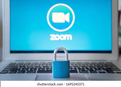 Bielsko-Biala, Poland - April 6. 2020: Blue Closed Metal Lock On Laptop Touchpad With Zoom Video Conference App Logo On The Laptot Screen In The Background. Zoom Data Security Issues Concept.