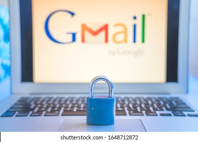 Bielsko-Biala, Poland - February 18. 2020: Blue closed metal lock on laptop touchpad with Gmail logo on the laptot screen in the background. Gmail security issues concept.