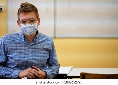 Bielsko-Biala, Slaskie/Poland - 10.13.2020: High School Student Wearing A Checked Shirt, Beige Pants And A Face Mask During A Classroom Lesson. Education During The Coronavirus Pandemic