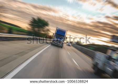 Big 18 wheeler semi truck on highway with motion blur